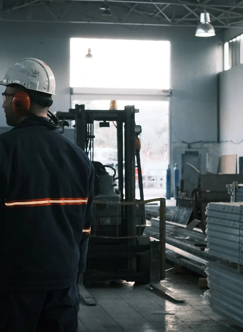 Worker overseeing machinery in a modern factory